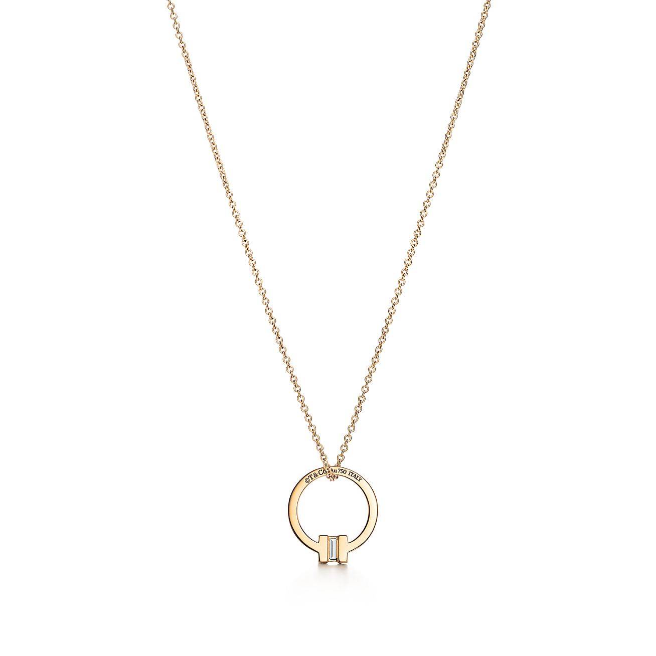 TIFFANY T PENDANT IN 18K GOLD WITH A BAGUETTE DIAMOND